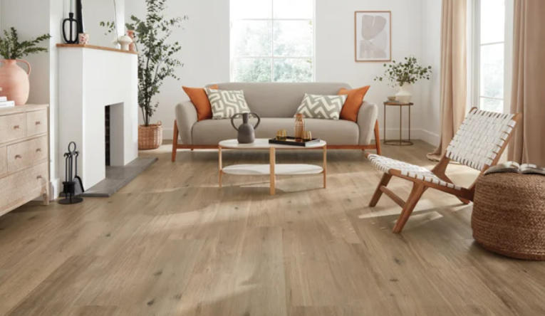 Modern living room with sofa, chairs, fireplace, and wooden flooring.