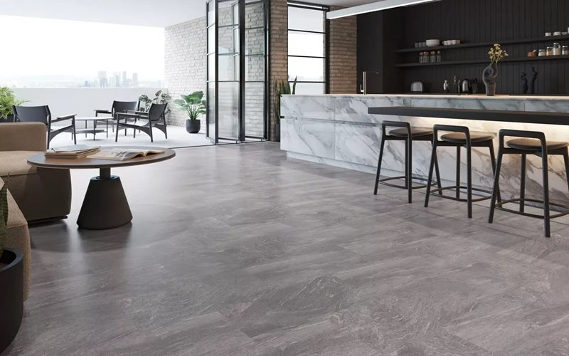 Tarkett Flooring the Grey Concrete Floor of a Modern Room with a Bar and Round Coffee Table